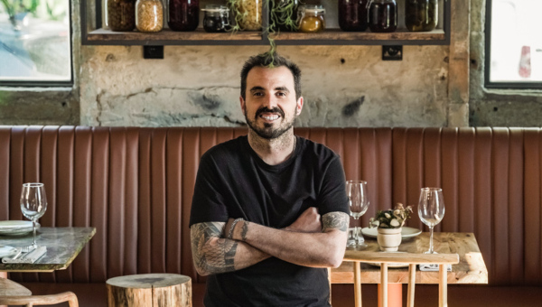0.Portuguese chefs redefining vegetarian and vegan cuisines_feat photo a man sitting at a table in front of a window
