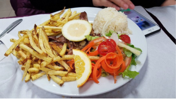 a plate of food that is on the side of fries