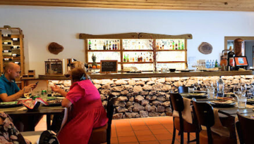 a group of people sitting at a table in a restaurant