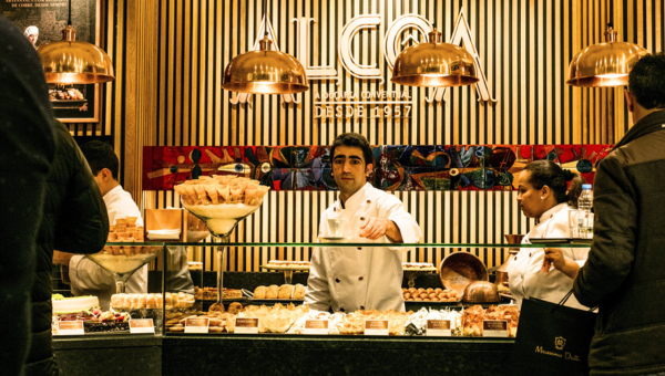 a group of people standing around a table