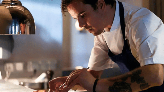 a man preparing food in a kitchen