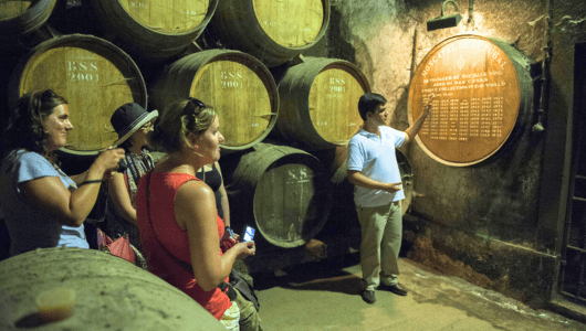 a group of people standing in front of a barrel