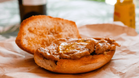a close up of a sandwich sitting on top of a wooden table