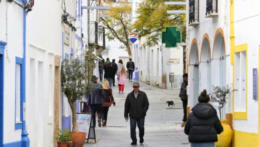 a group of people walking on a city street