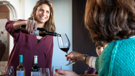 Jackie DeAngelis holding a bottle of wine