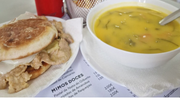 a bowl of soup and a sandwich on a plate