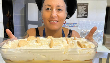 a woman standing in front of a cake