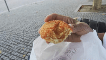 a hand holding a piece of food