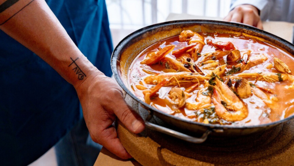 a person cooking food in a bowl