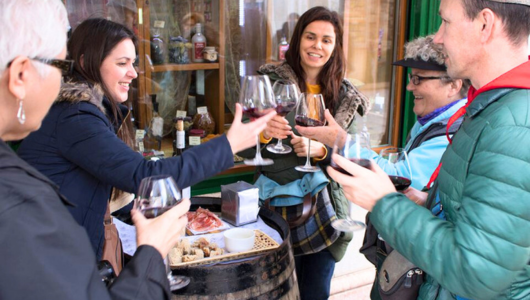 a group of people holding wine glasses