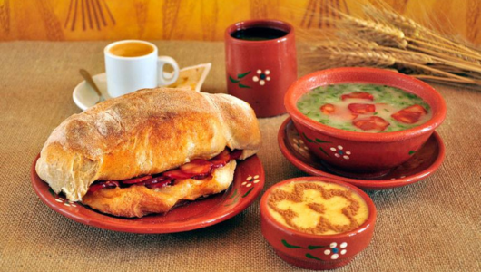 a table topped with a sandwich and a cup of coffee