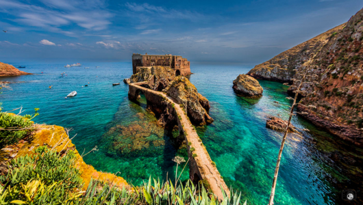 a rocky shore next to a body of water