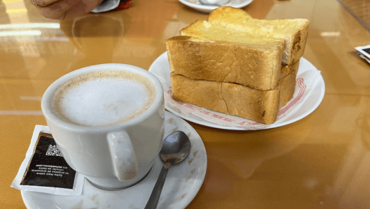 a plate with a sandwich and a cup of coffee