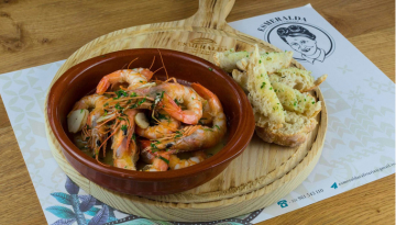a plate of food sitting on top of a wooden table