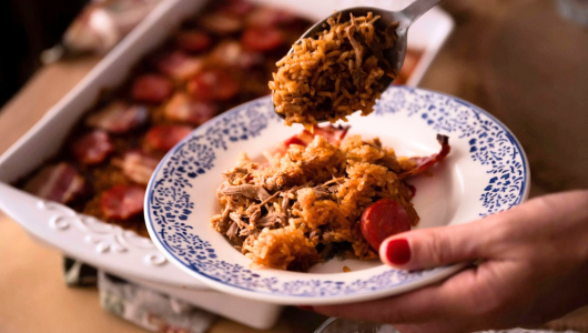 a person holding a plate of food