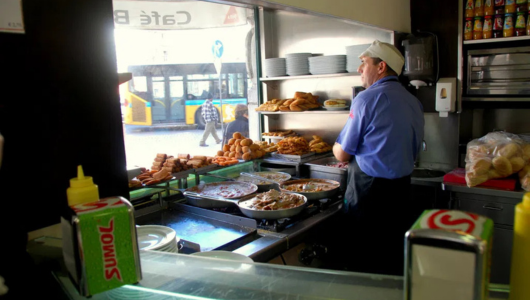 a person standing in a kitchen preparing food
