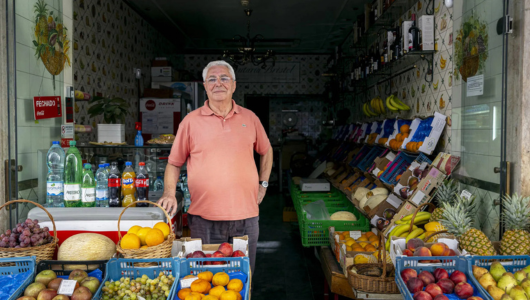 a person standing in front of a fruit stand