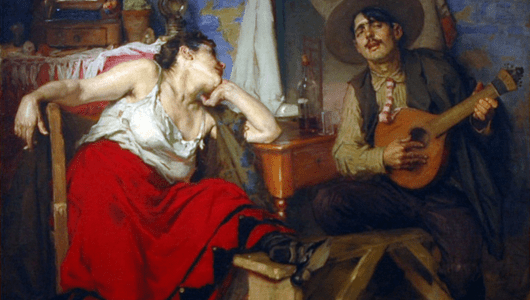 A woman in a red skirt listens to a man playing a guitar in a rustic room.