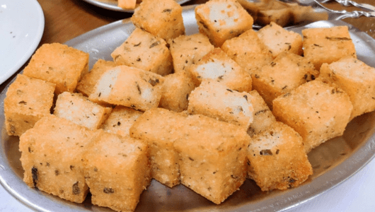 A tray of golden-brown fried tofu cubes.