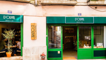 Exterior of a shop named D'Olival with green signage and open doors.