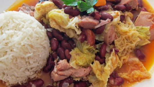 Rice with cabbage, kidney beans, and meat served on a plate.