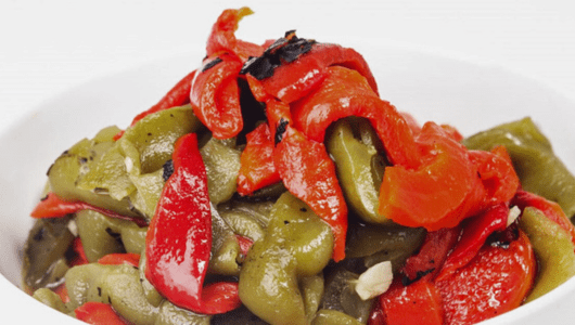 A bowl of roasted red and green bell pepper strips.