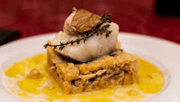 Gourmet fish dish with herbs on squash.