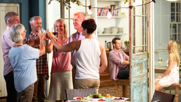 Group of people toasting drinks in a cozy indoor setting.