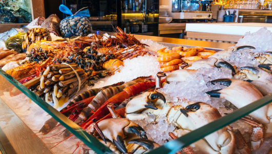 Assorted seafood on ice display, including crabs and shrimp.
