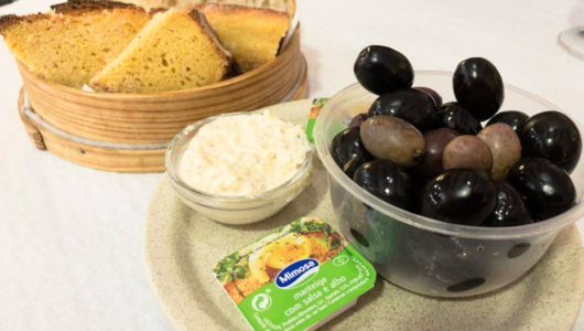 Bread, olives, and cheese spread on a table.