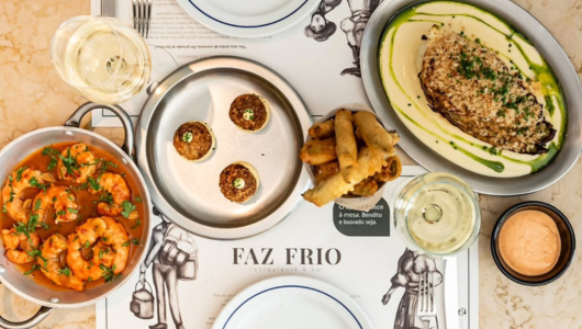 An overhead view of a restaurant table with various dishes and drinks.