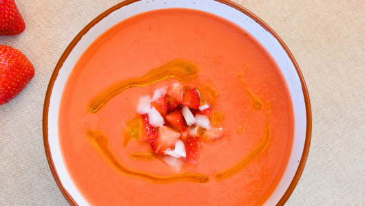 Bowl of strawberry soup with diced strawberries on top