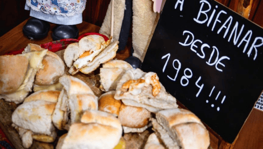 Sandwiches on a board with a sign reading 'A Bifana Desde 1984.'