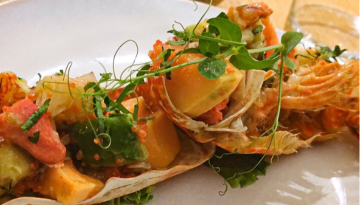 Gourmet dish with vegetables and microgreens on a plate.